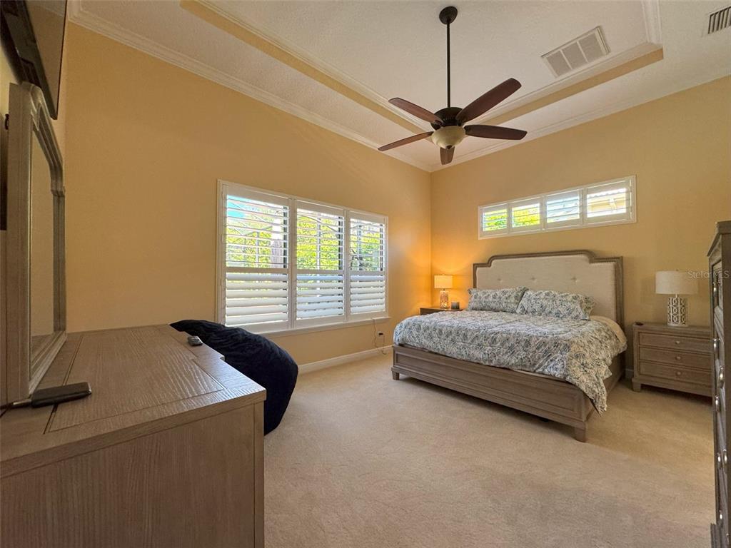 1024 West Beagle Run Loop Hernando, FL 34442 - Photo 26 of 44 a bedroom with a bed and a chandelier