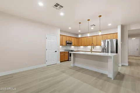 a kitchen with stainless steel appliances granite countertop cabinets and a stove top oven