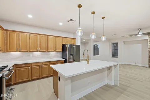 a kitchen with a stove a sink and a refrigerator