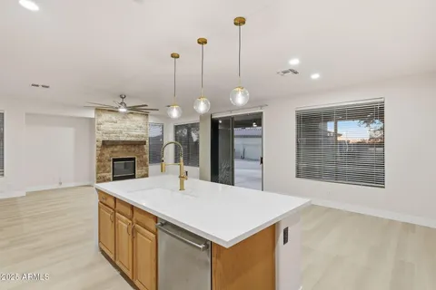 an empty room with an entryway and fan