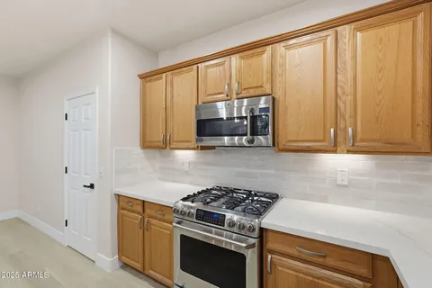 an empty room with a ceiling fan and a window