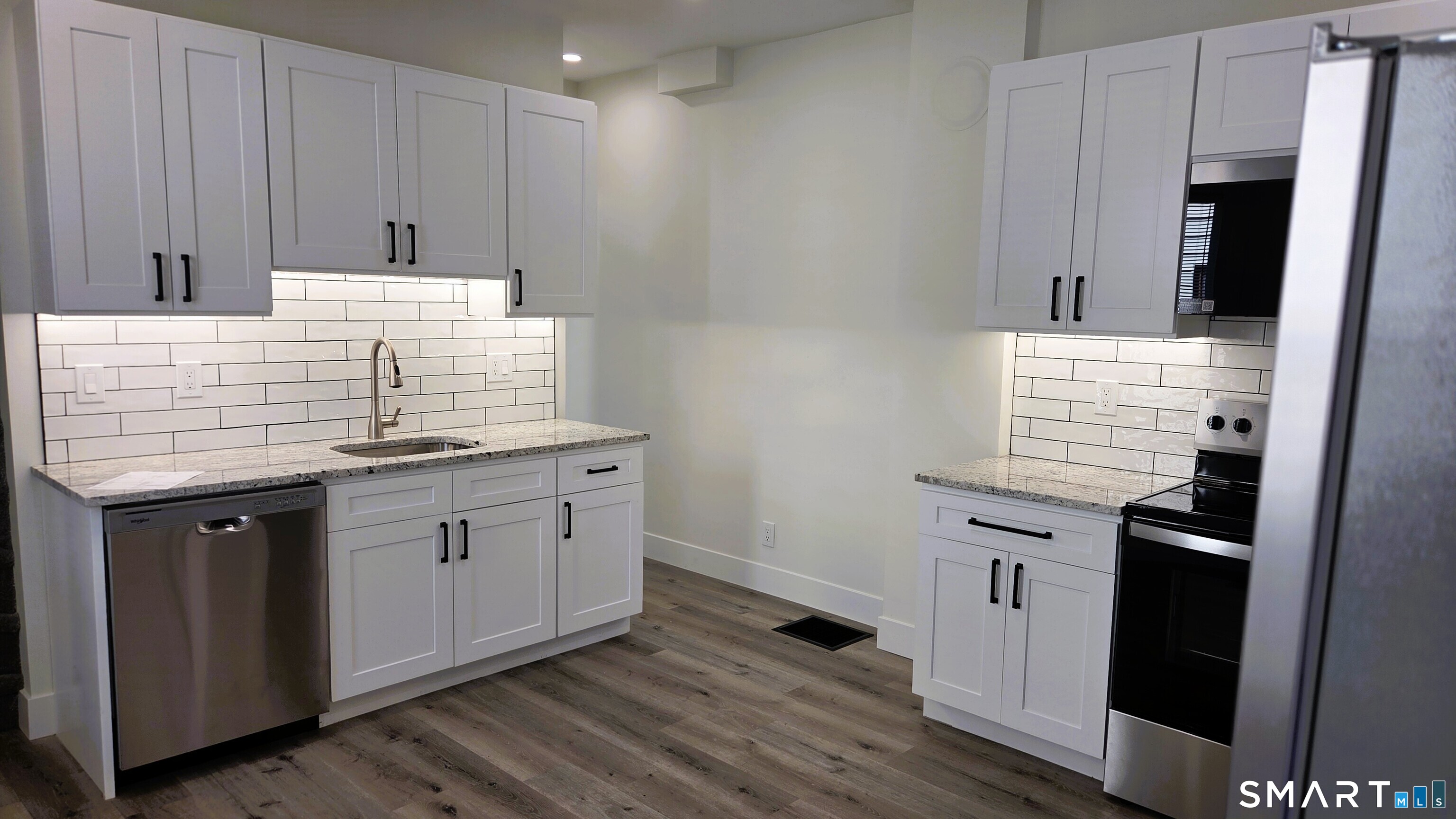 14 Meadow Street Ansonia, CT 06401 - Photo 1 of 25 a kitchen with granite countertop white cabinets and white appliances