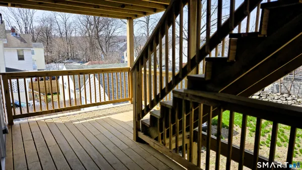 a view of staircase with wooden floor and stairs