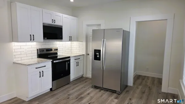 a kitchen with stainless steel appliances a refrigerator microwave and sink
