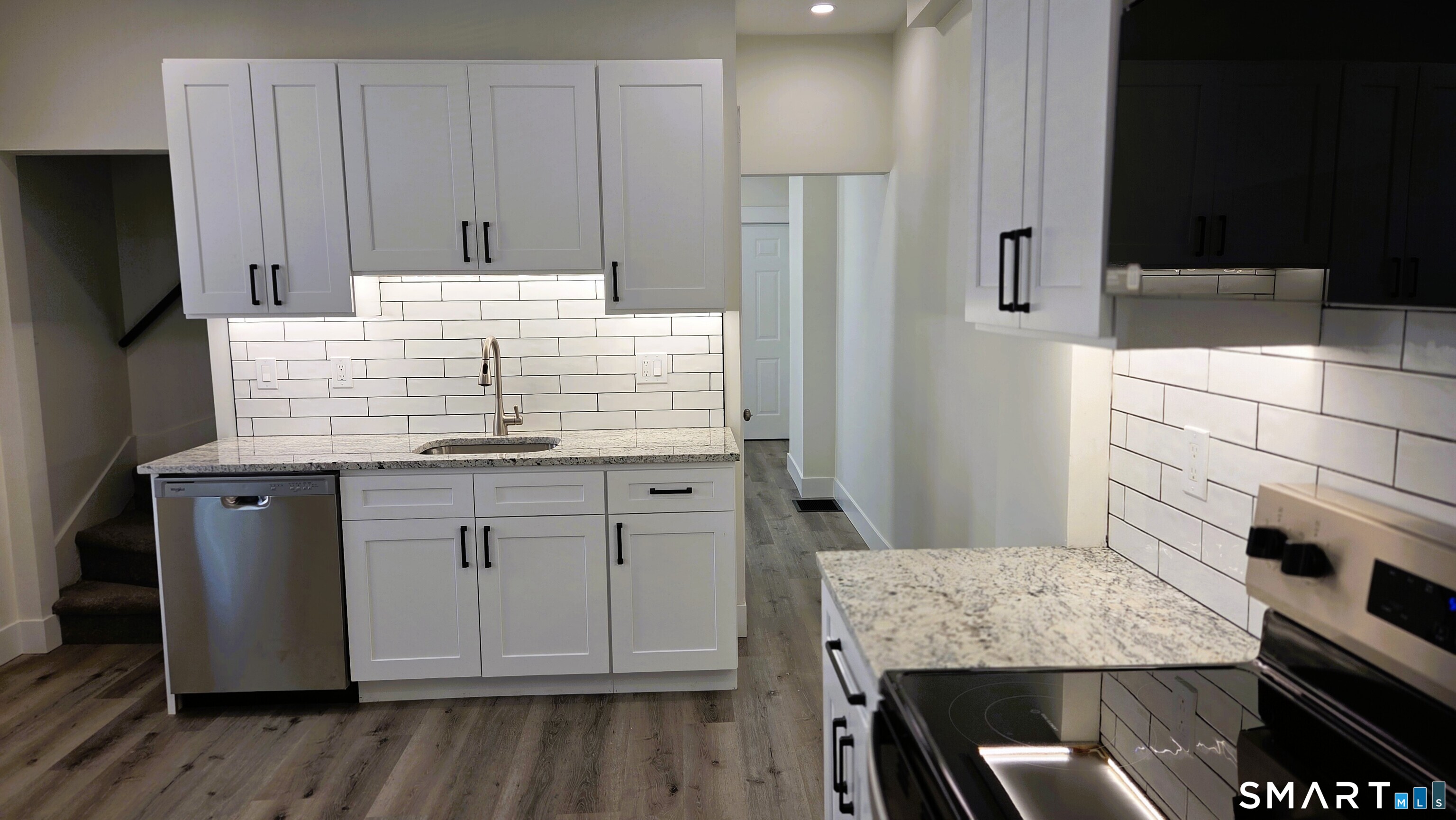 14 Meadow Street Ansonia, CT 06401 - Photo 6 of 25 a kitchen with kitchen island cabinets and refrigerator