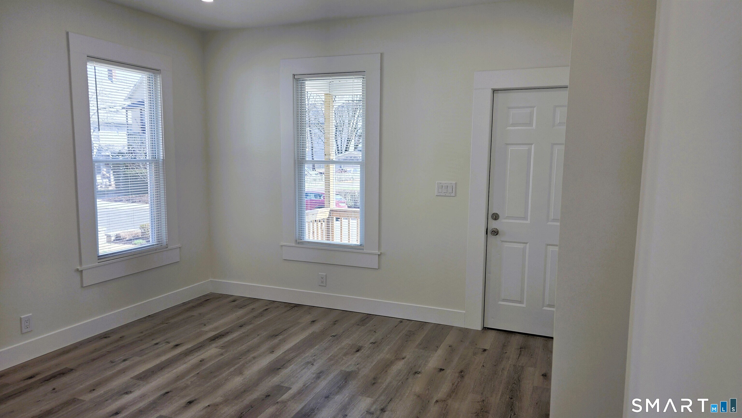 14 Meadow Street Ansonia, CT 06401 - Photo 9 of 25 a view of an empty room with wooden floor and a window