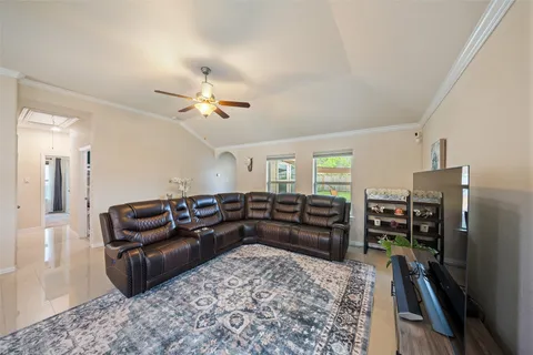 a living room with furniture and wooden floor