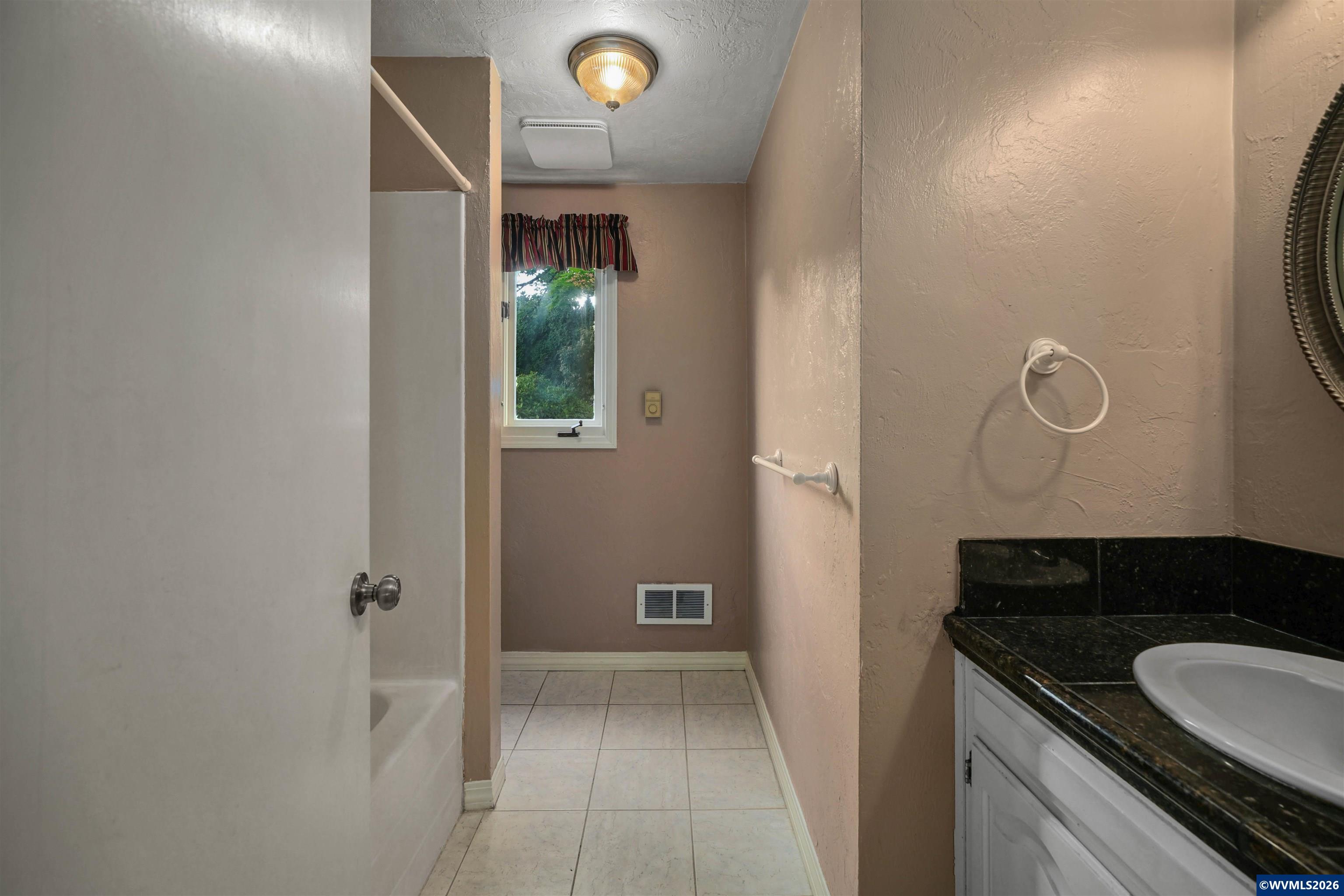 220 Northwest Downy Drive Sublimity, OR 97385 - Photo 25 of 47 a bathroom with a granite countertop sink and a mirror