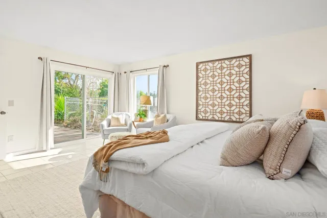 a bedroom with a bed and a large window