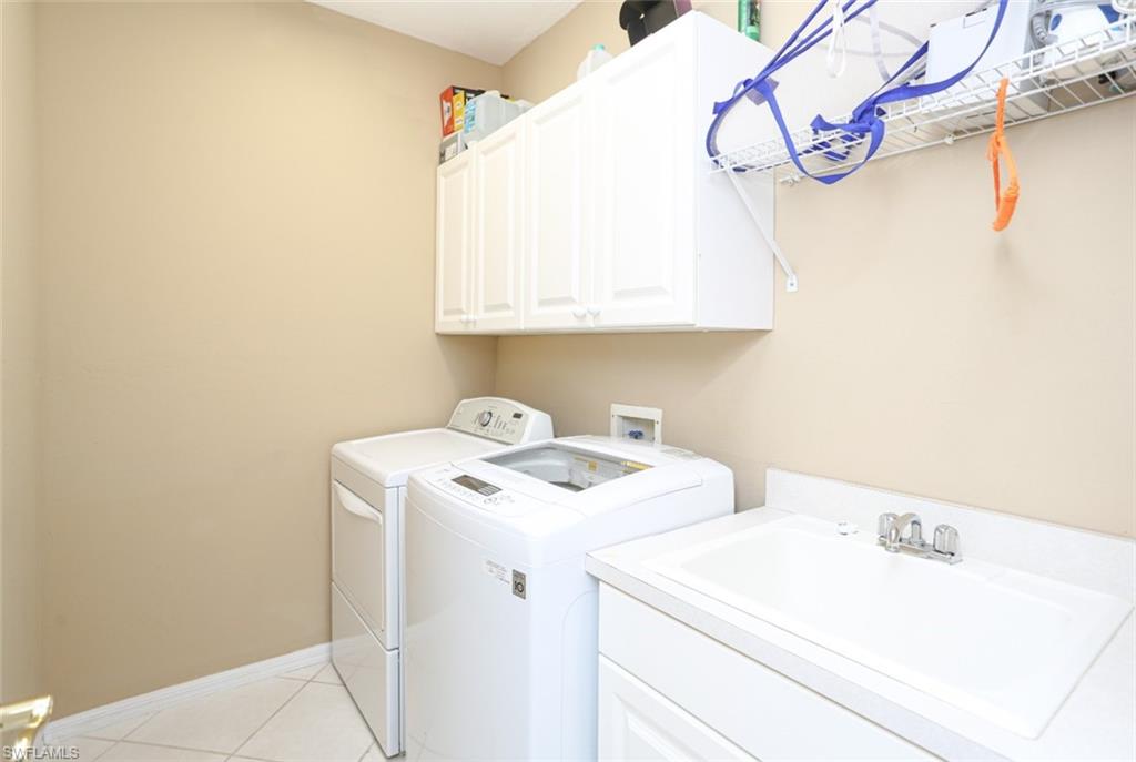164 Spring Lake Circle Naples, FL 34119 - Photo 12 of 36 a utility room with dryer and washer