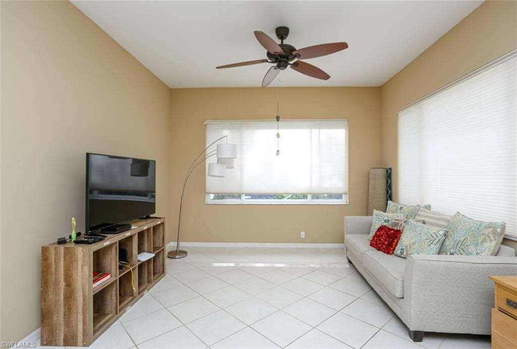 164 Spring Lake Circle Naples, FL 34119 - Photo 17 of 36 a living room with furniture and a flat screen tv