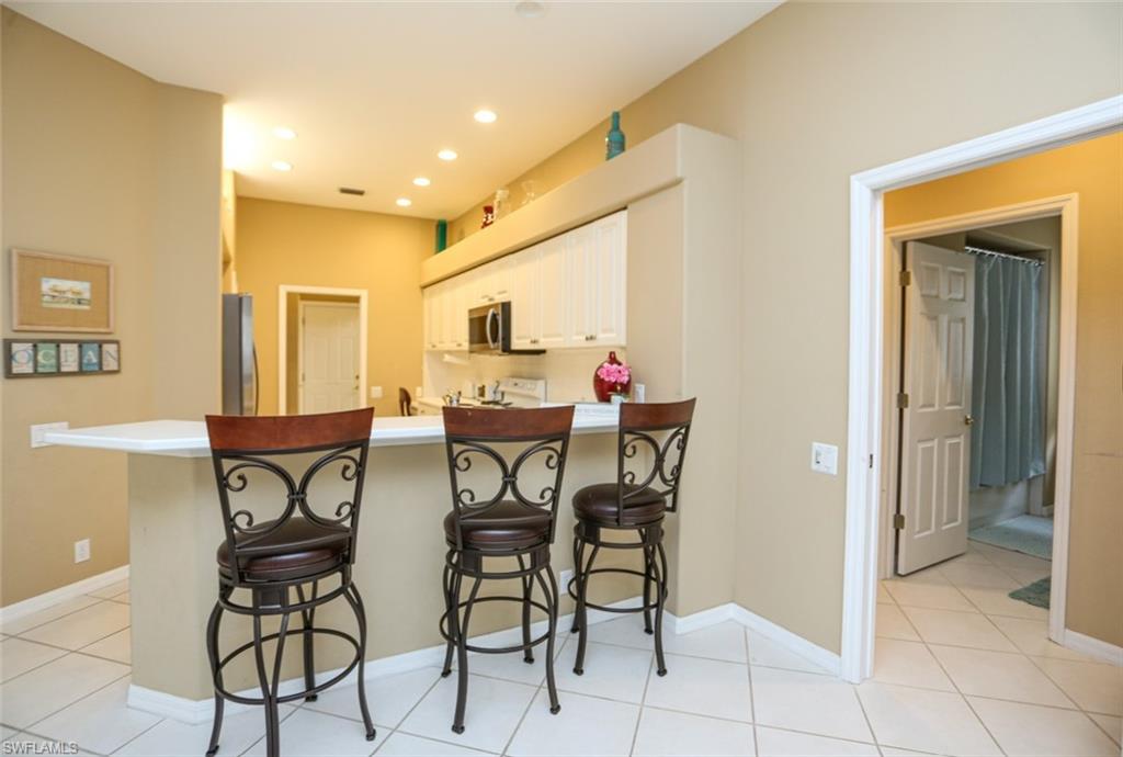 164 Spring Lake Circle Naples, FL 34119 - Photo 18 of 36 a view of a dining room with furniture