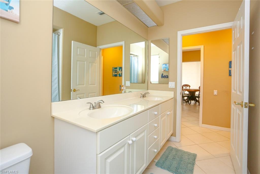 164 Spring Lake Circle Naples, FL 34119 - Photo 20 of 36 a spacious bathroom with a sink a mirror and a bathtub