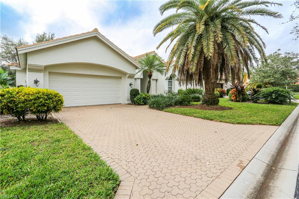 164 Spring Lake Circle Naples, FL 34119 - Photo 2 of 36 a front view of house with yard and green space