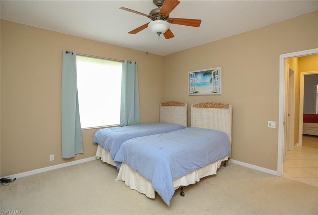 164 Spring Lake Circle Naples, FL 34119 - Photo 21 of 36 a bedroom with a bed and window