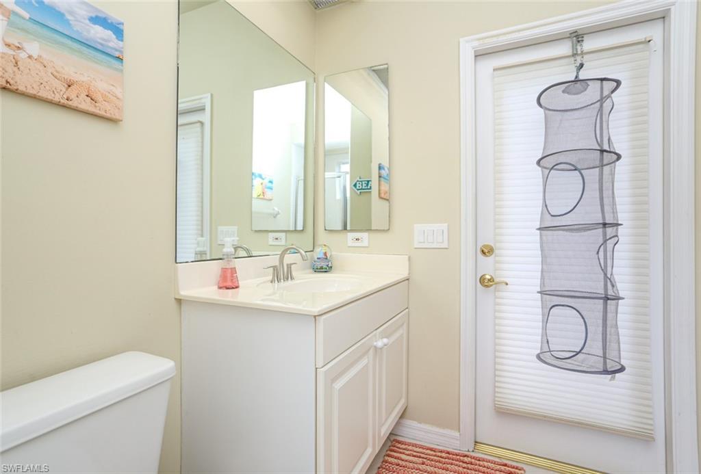164 Spring Lake Circle Naples, FL 34119 - Photo 25 of 36 a bathroom with a sink toilet and shower