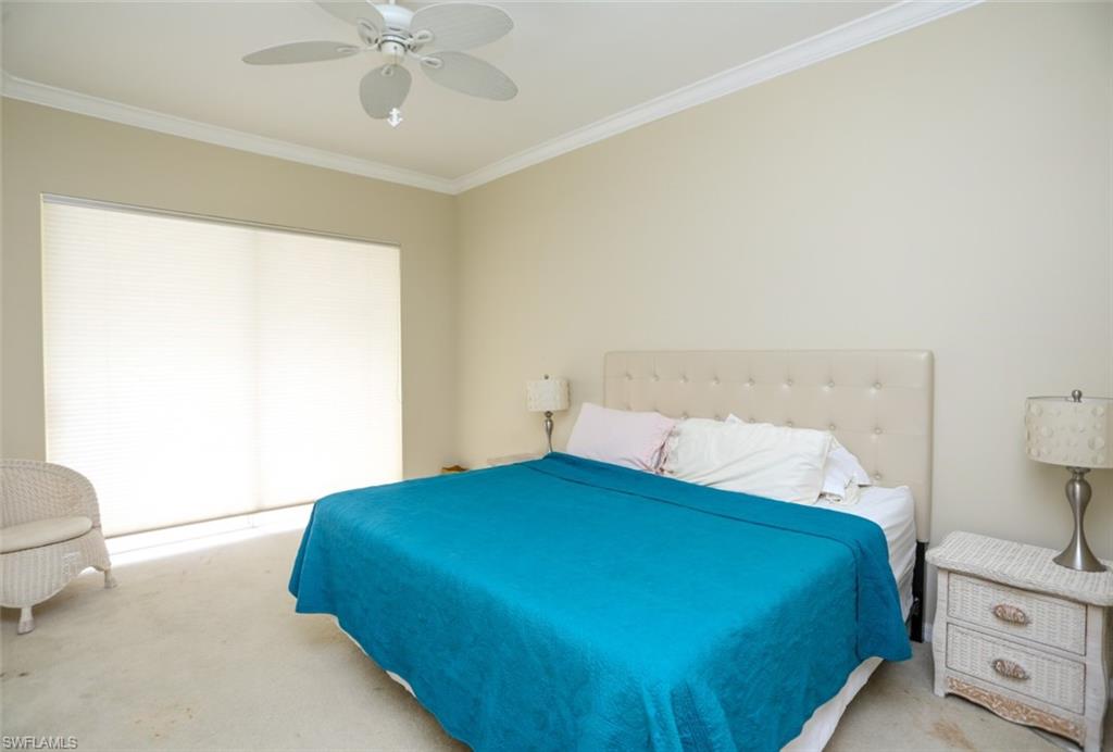 164 Spring Lake Circle Naples, FL 34119 - Photo 29 of 36 a bedroom with a bed and a window
