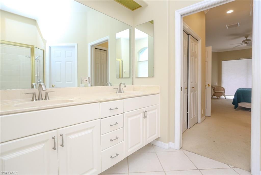 164 Spring Lake Circle Naples, FL 34119 - Photo 34 of 36 a bathroom with a sink vanity and a mirror