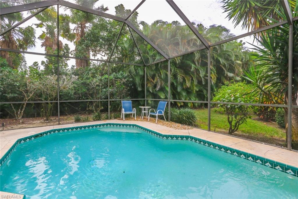 164 Spring Lake Circle Naples, FL 34119 - Photo 35 of 36 a view of a backyard with a small park