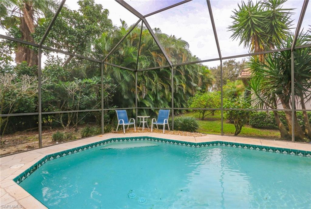 164 Spring Lake Circle Naples, FL 34119 - Photo 36 of 36 a view of a swimming pool with a lake view
