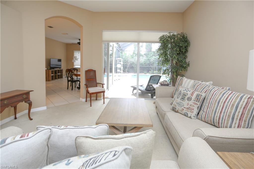 164 Spring Lake Circle Naples, FL 34119 - Photo 7 of 36 a living room with furniture and a large window