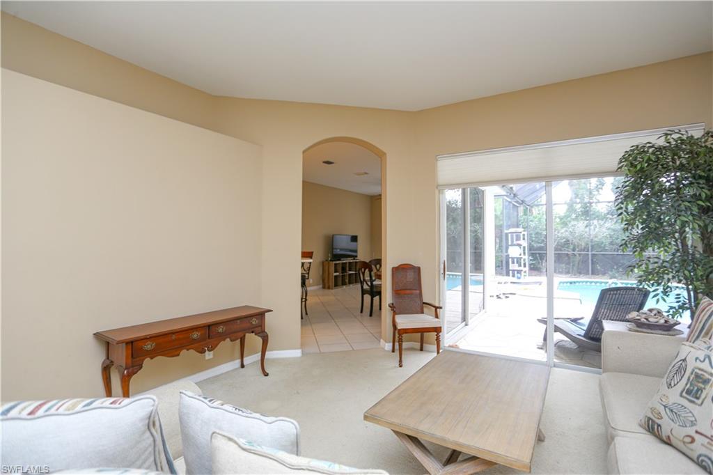164 Spring Lake Circle Naples, FL 34119 - Photo 8 of 36 a living room with furniture and a potted plant