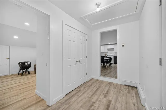 a view of a hallway and wooden floor a living room