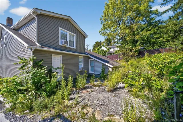 a view of a house with a small yard and plants