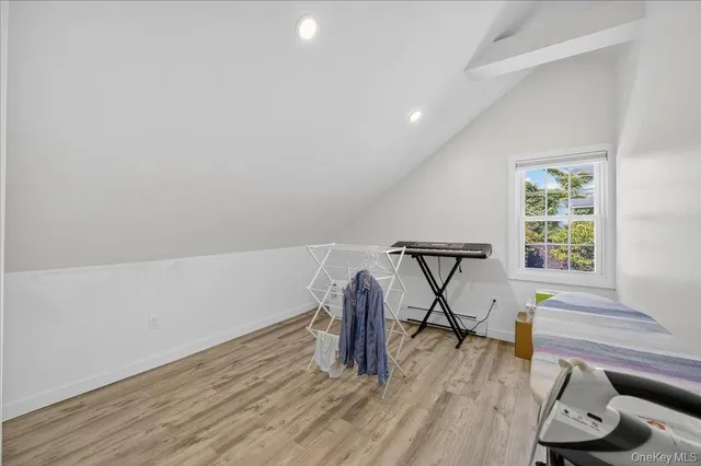 a view of a room with wooden floor and fan