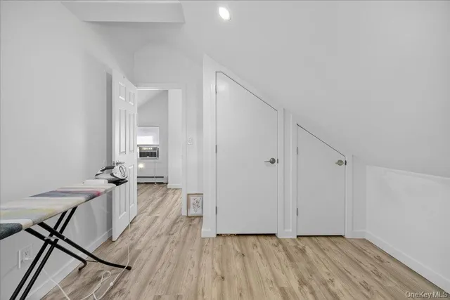 a view of a room with wooden floor