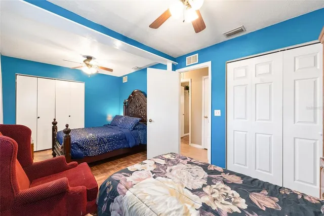 a bedroom with bed and a chandelier