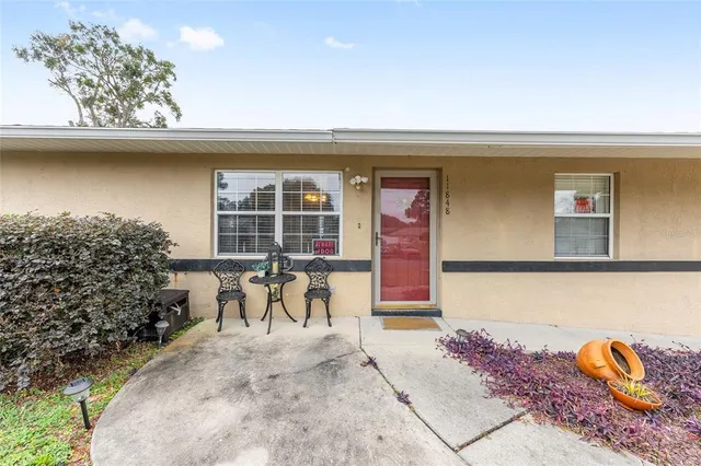 a front view of a house with outdoor seating