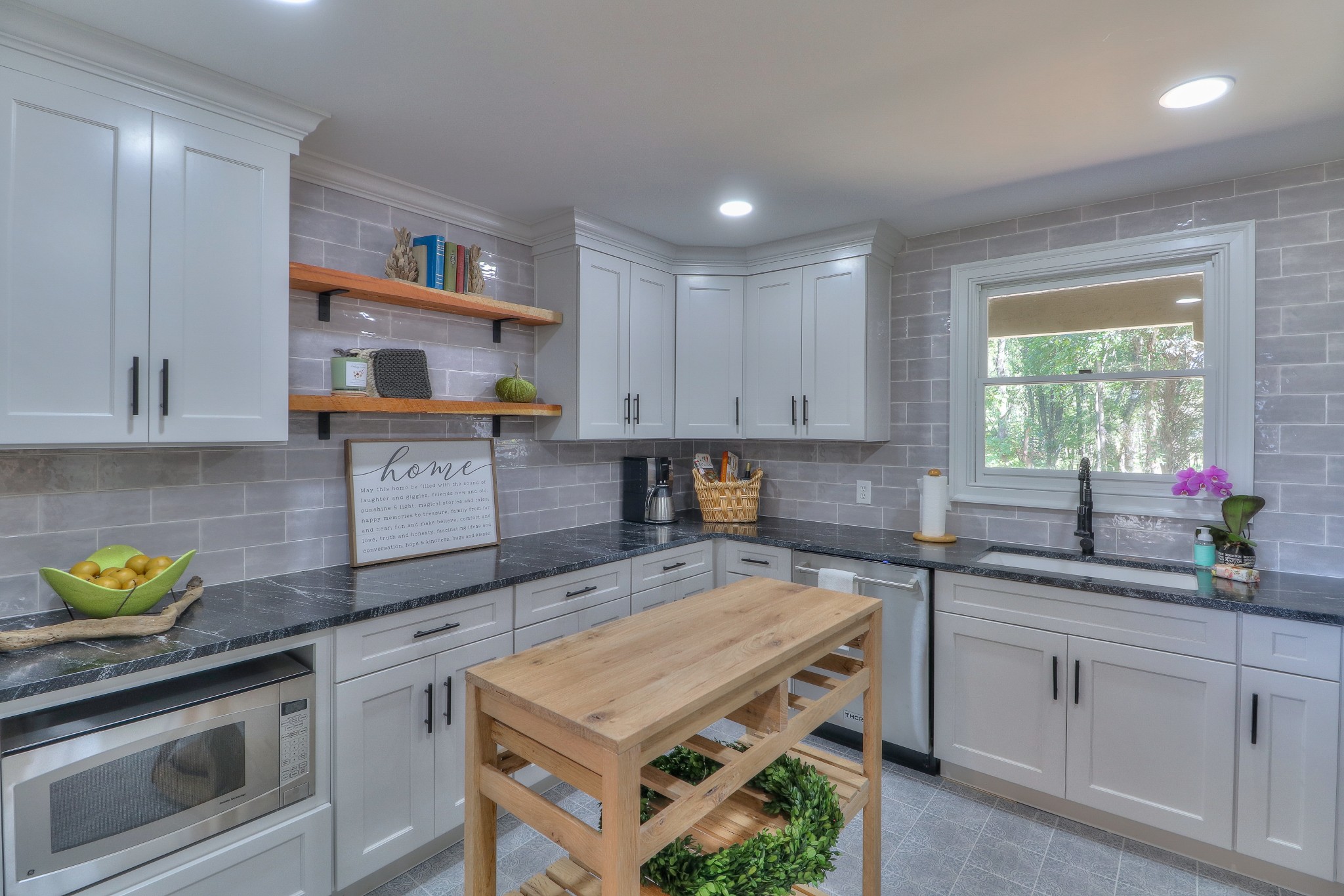 653 Flippen Road Lebanon, TN 37087 - Photo 11 of 49 a kitchen with kitchen island granite countertop a sink a stove and cabinets