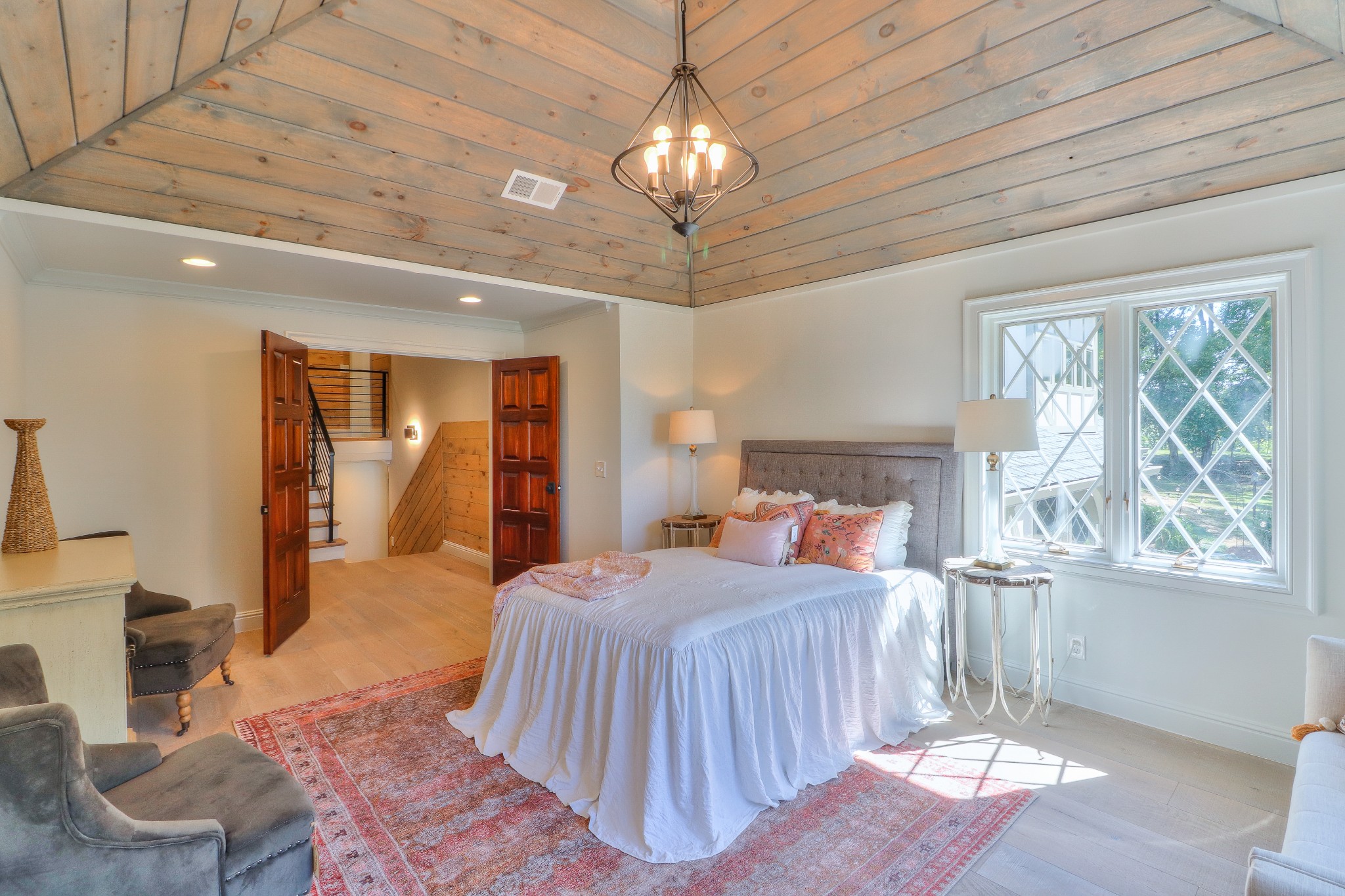 653 Flippen Road Lebanon, TN 37087 - Photo 22 of 49 a bedroom with a large bed a chandelier and windows