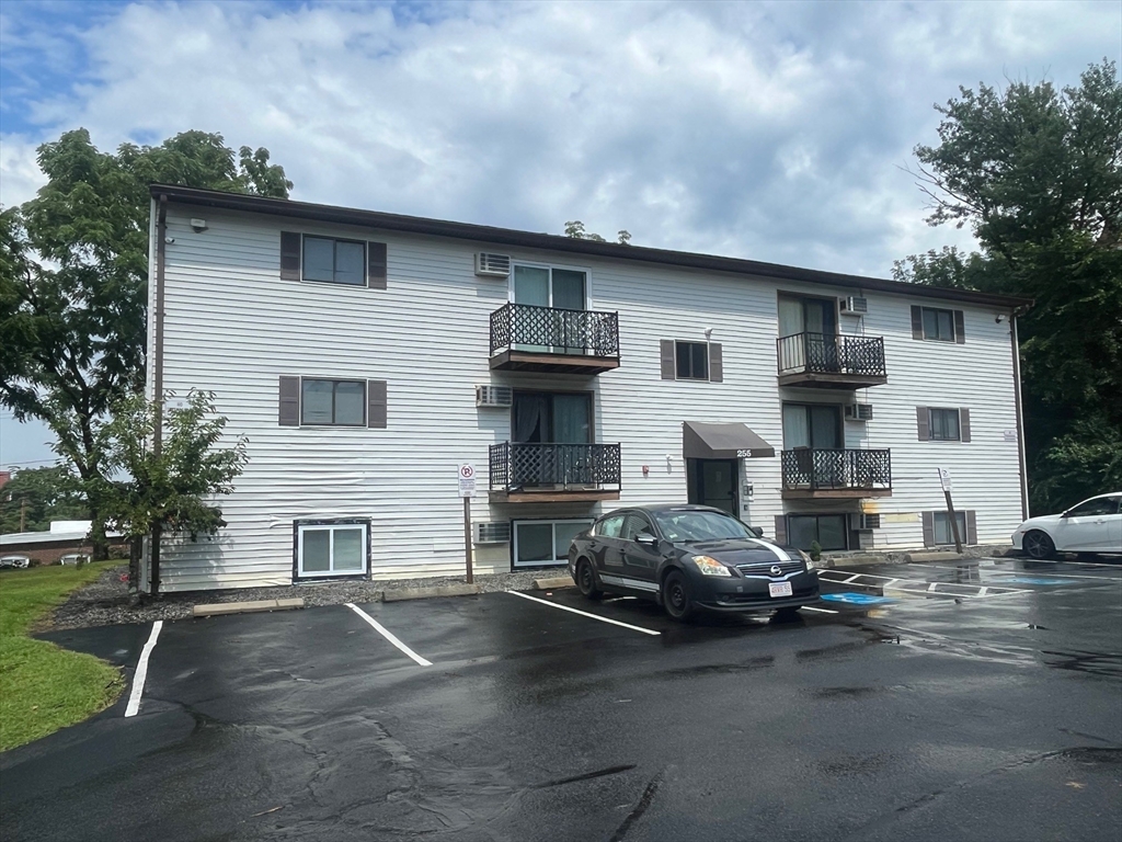 a front view of a house with parking space