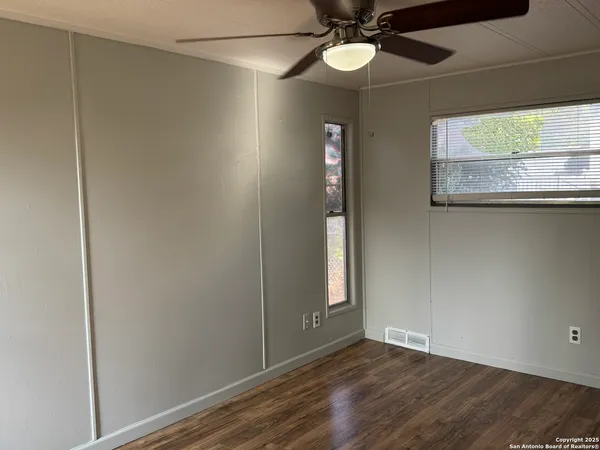 a view of a room with wooden floor