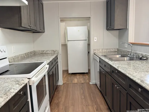 a kitchen with a sink stove and cabinets