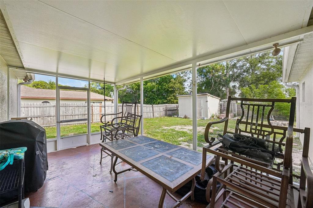 10303 Fordham Street Spring Hill, FL 34608 - Photo 20 of 25 a view of a chairs and table in the patio