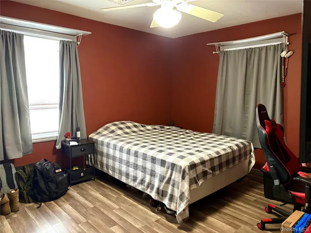 a bedroom with a bed and a mirror