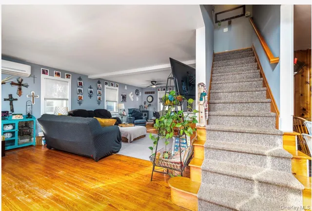 a living room with furniture and a potted plant