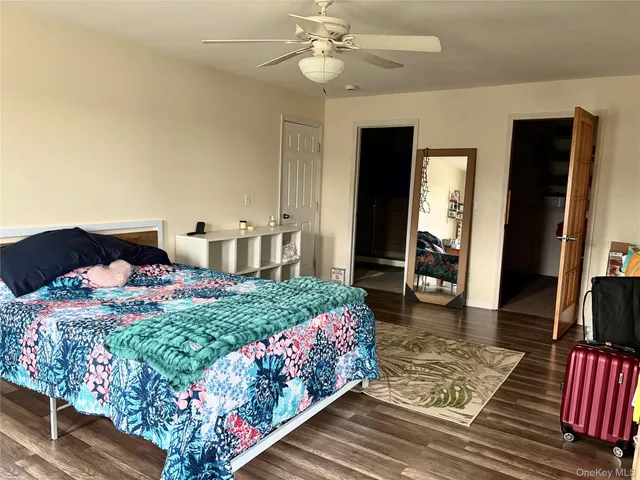 a bedroom with bed and a chandelier