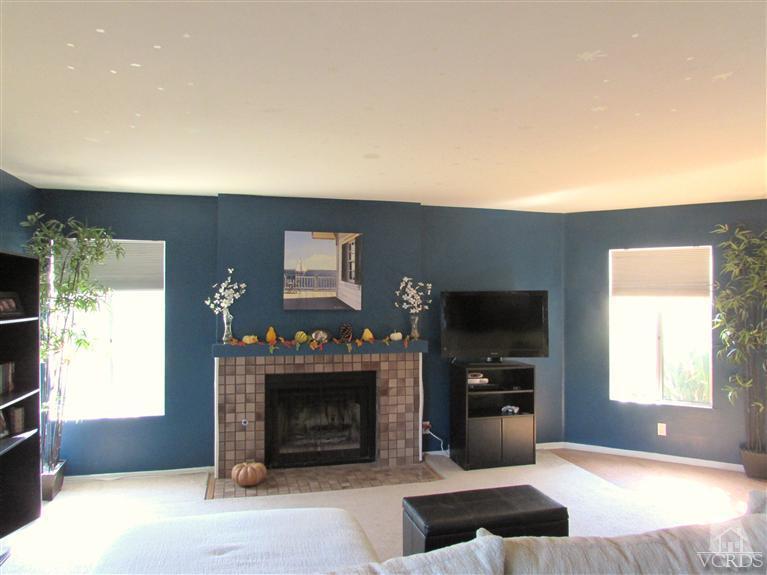 1742 Sinaloa Road, Unit 344 Simi Valley, CA 93065 - Photo 2 of 20 a living room with furniture a flat screen tv and a fireplace