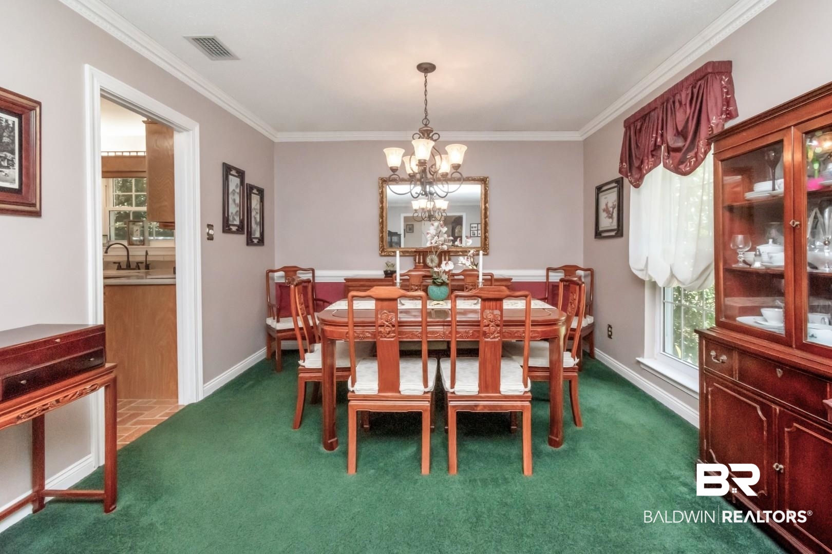 8220 Fordham Road Mobile, AL 36619 - Photo 12 of 41 Dining space featuring a notable chandelier, baseboards, visible vents, crown molding, and dark carpet