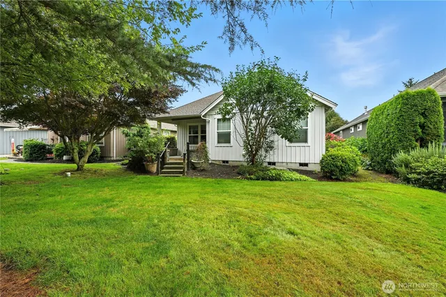 a front view of house with yard and green space