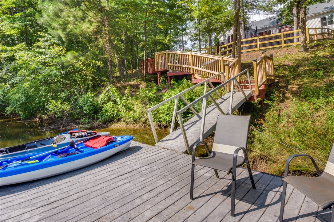 206 Petty Road Seneca, SC 29672 - Photo 43 of 48 A tranquil lakefront setting offers a private dock with direct water access and surrounding lush greenery.