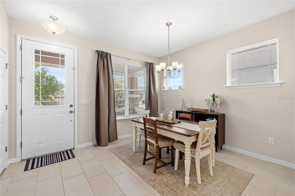 16716 Wingspread Loop Winter Garden, FL 34787 - Photo 11 of 56 a view of a dining room with furniture window and outside view