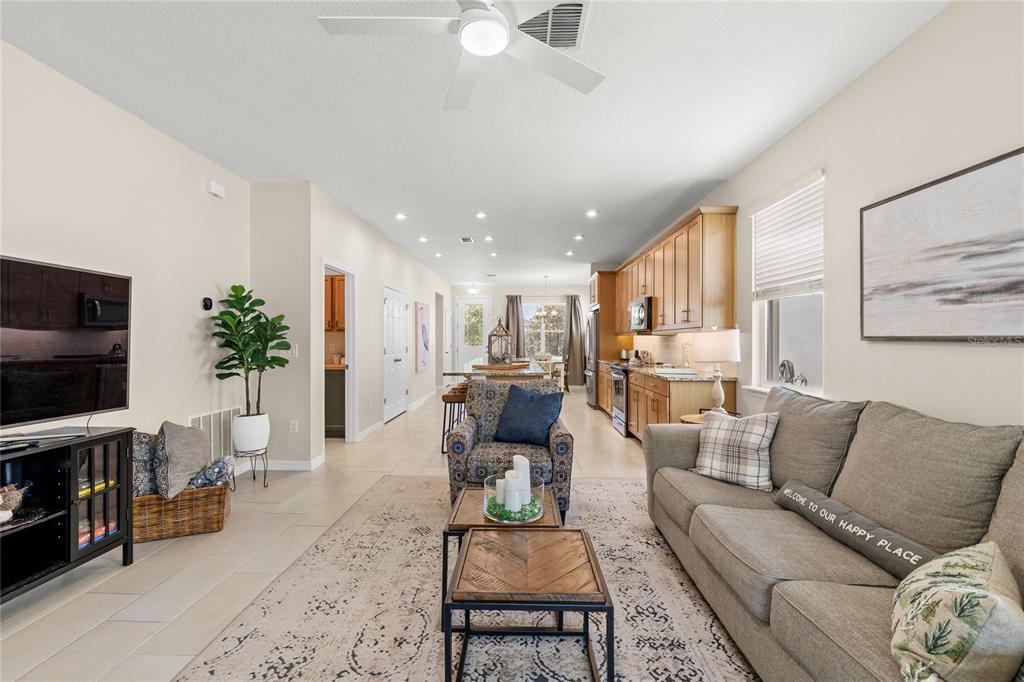 16716 Wingspread Loop Winter Garden, FL 34787 - Photo 13 of 56 a living room with furniture and a flat screen tv