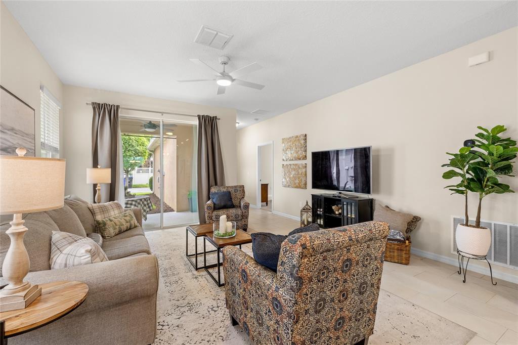 16716 Wingspread Loop Winter Garden, FL 34787 - Photo 15 of 56 a living room with furniture a flat screen tv and a large window