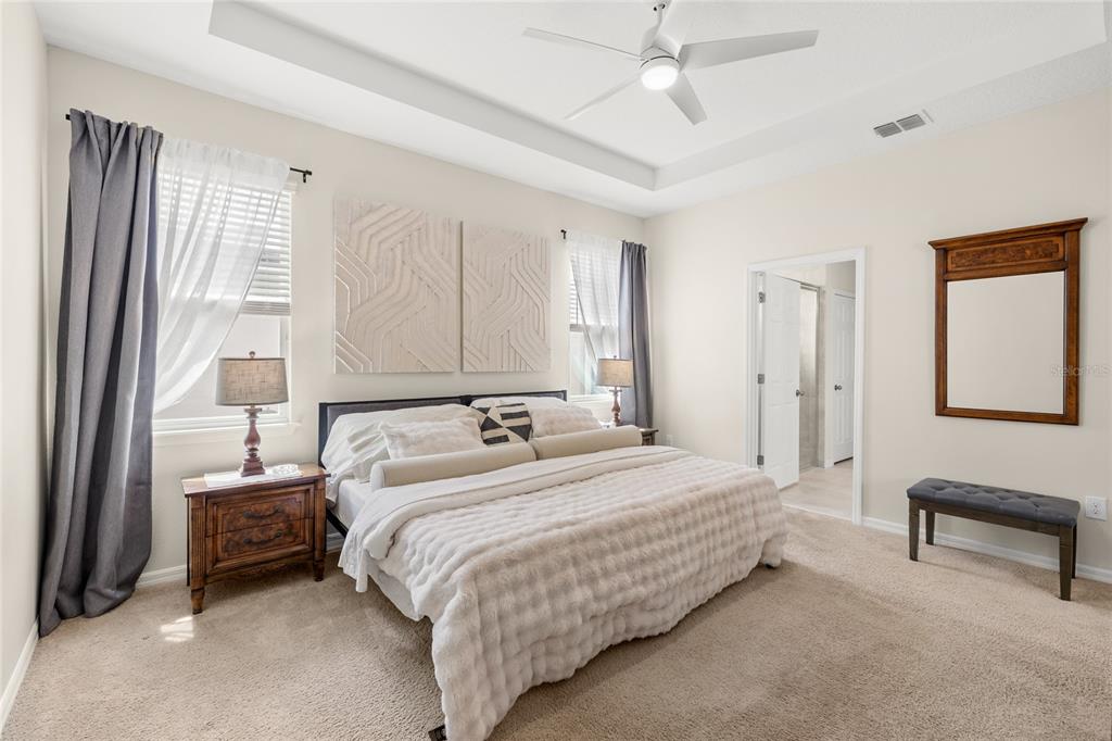 16716 Wingspread Loop Winter Garden, FL 34787 - Photo 16 of 56 a bedroom with a bed and a chandelier