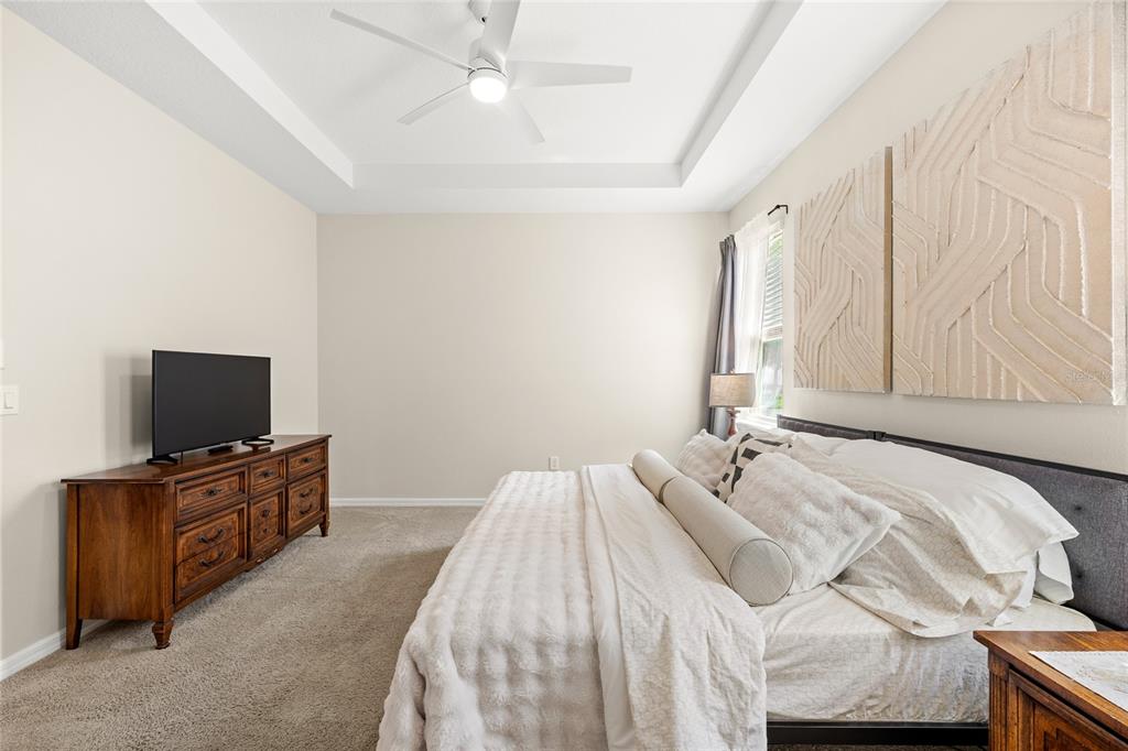 16716 Wingspread Loop Winter Garden, FL 34787 - Photo 17 of 56 a bedroom with a bed and a flat screen tv